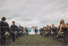 Wide view of a romantic lakeside wedding ceremony setup in Michigan, photographed by Karl Lascano.