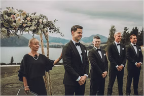 Groom smiles emotionally as he sees his bride for the first time at their Michigan lakefront ceremony.