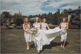 Bride walks with her bridesmaids before the ceremony at a Michigan lakeside wedding, captured by Karl Lascano